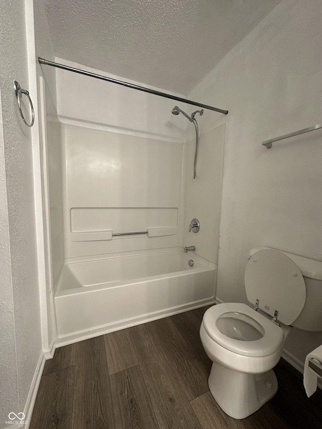 12639 Justice Xing, Fishers, IN 46037 - full bath featuring a textured ceiling, wood finished floors, and shower / washtub combination