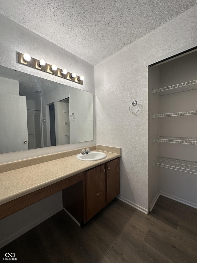 12639 Justice Xing, Fishers, IN 46037 - full bathroom featuring a textured wall, wood finished floors, vanity, and a textured ceiling