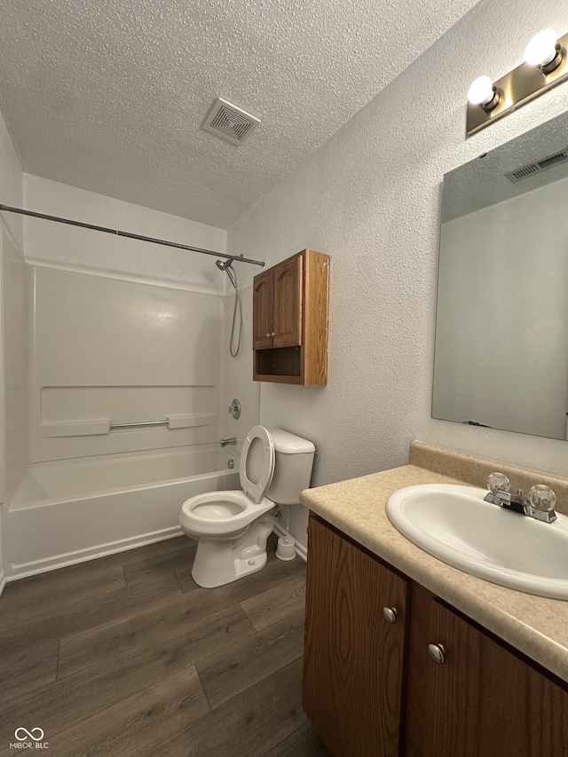 12639 Justice Xing, Fishers, IN 46037 - bathroom with vanity, wood finished floors, tub / shower combination, a textured ceiling, and a textured wall