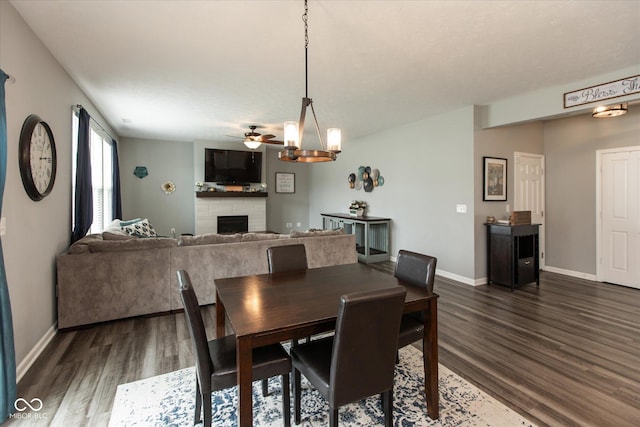 10334 Deercrest Ln, Indianapolis, IN 46239 - dining space with dark wood finished floors, a fireplace, and a ceiling fan