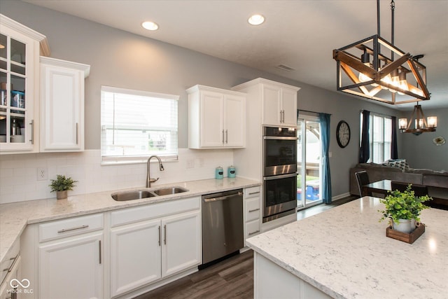 10334 Deercrest Ln, Indianapolis, IN 46239 - kitchen with stainless steel appliances, white cabinetry, backsplash, glass insert cabinets, and recessed lighting