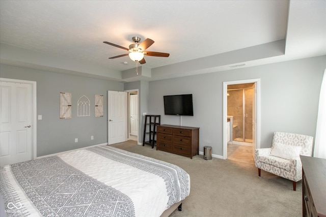10334 Deercrest Ln, Indianapolis, IN 46239 - bedroom with light colored carpet, a raised ceiling, a ceiling fan, and ensuite bath