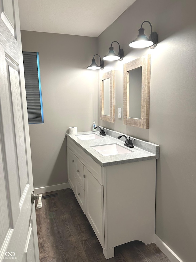 712 W Main St, Thorntown, IN 46071 - full bathroom with wood finished floors and double vanity