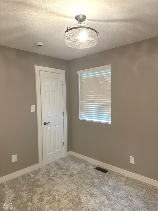 712 W Main St, Thorntown, IN 46071 - carpeted spare room featuring a textured ceiling and a smoke detector