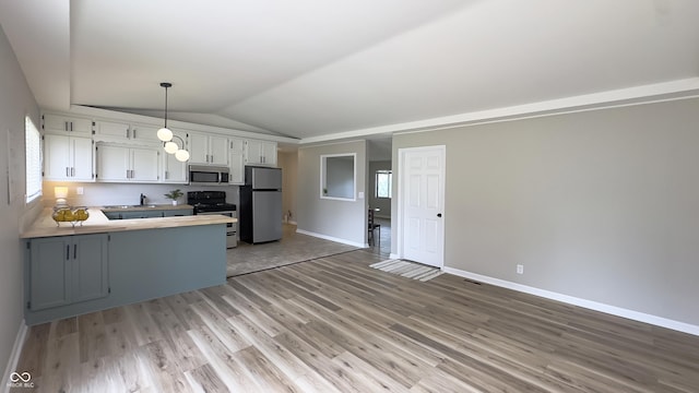 3019 E Berwyn St, Indianapolis, IN 46203 - kitchen with appliances with stainless steel finishes, a peninsula, vaulted ceiling, light wood-type flooring, and white cabinets