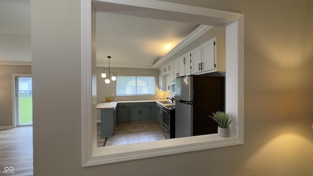 3019 E Berwyn St, Indianapolis, IN 46203 - kitchen featuring freestanding refrigerator, ornamental molding, range with electric stovetop, light countertops, and white cabinets