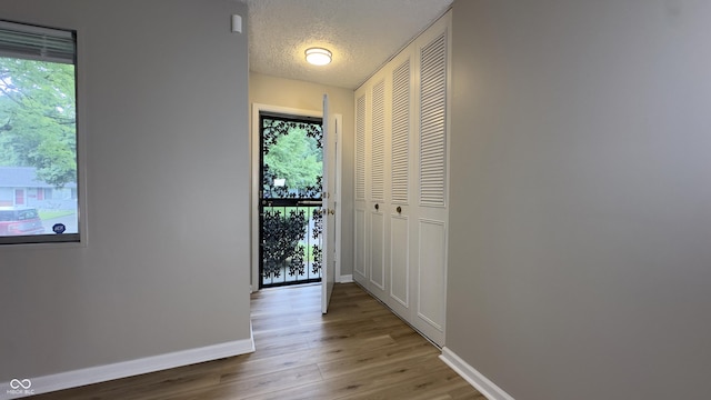 3019 E Berwyn St, Indianapolis, IN 46203 - hall featuring wood finished floors and a textured ceiling