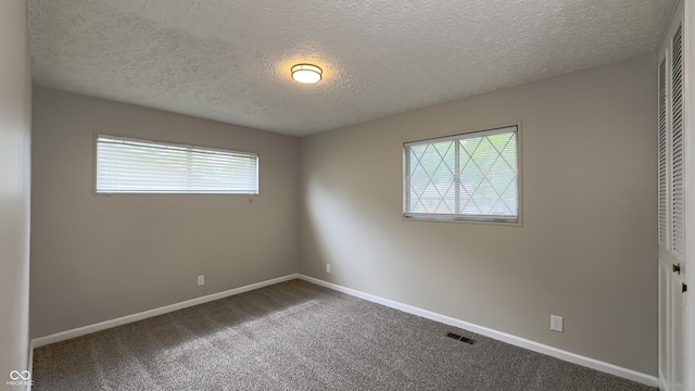 3019 E Berwyn St, Indianapolis, IN 46203 - unfurnished bedroom featuring a textured ceiling, a closet, and carpet floors