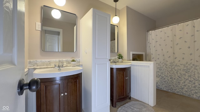 3019 E Berwyn St, Indianapolis, IN 46203 - full bathroom with tile patterned floors, two vanities, and a shower with shower curtain