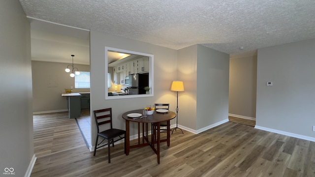 3019 E Berwyn St, Indianapolis, IN 46203 - dining area featuring wood finished floors and a textured ceiling