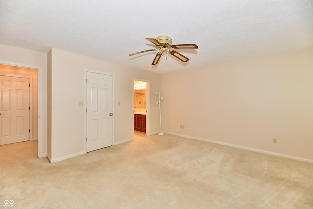 6965 Steinmeier Dr W, Indianapolis, IN 46220 - unfurnished bedroom with light colored carpet, ensuite bath, and ceiling fan