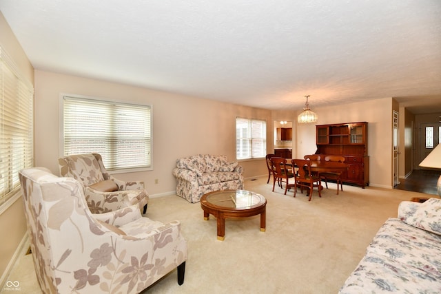 6965 Steinmeier Dr W, Indianapolis, IN 46220 - living area featuring healthy amount of natural light, light colored carpet, and a chandelier