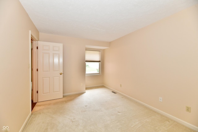 6965 Steinmeier Dr W, Indianapolis, IN 46220 - spare room featuring light carpet and a textured ceiling