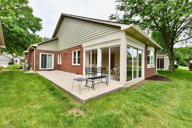 6965 Steinmeier Dr W, Indianapolis, IN 46220 - rear view of house featuring a patio, brick siding, and a yard