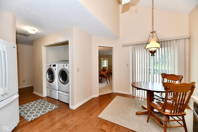 6965 Steinmeier Dr W, Indianapolis, IN 46220 - washroom with washer and clothes dryer, wood finished floors, and a high ceiling