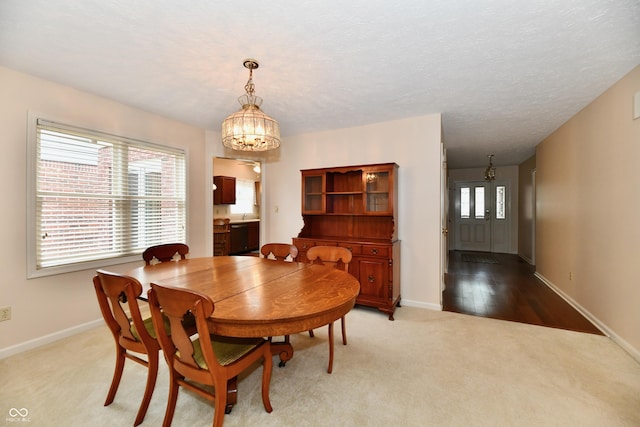 6965 Steinmeier Dr W, Indianapolis, IN 46220 - dining room featuring a chandelier and light colored carpet