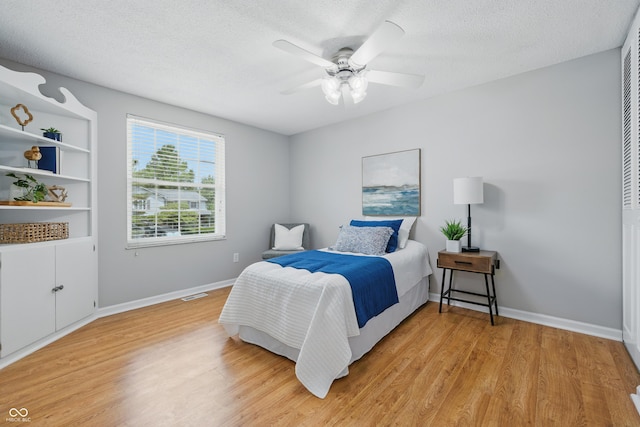 5503 Antoneli Ln, Indianapolis, IN 46237 - bedroom featuring light wood-style flooring, a textured ceiling, and a ceiling fan