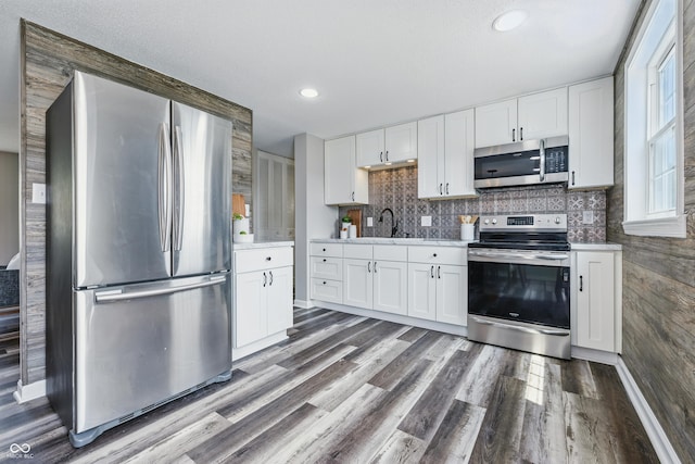 5503 Antoneli Ln, Indianapolis, IN 46237 - kitchen featuring stainless steel appliances, dark wood-type flooring, white cabinetry, light countertops, and tasteful backsplash