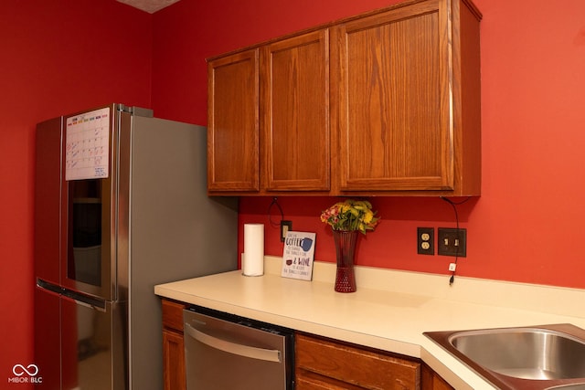 6585 Dunsdin Dr, Plainfield, IN 46168 - kitchen with stainless steel appliances, light countertops, and brown cabinets