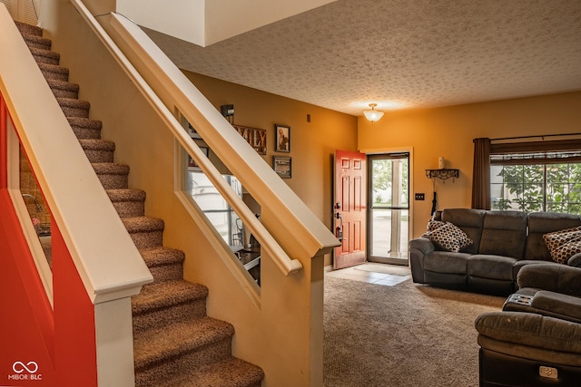 6585 Dunsdin Dr, Plainfield, IN 46168 - tiled living room with stairs, plenty of natural light, a textured ceiling, and carpet floors