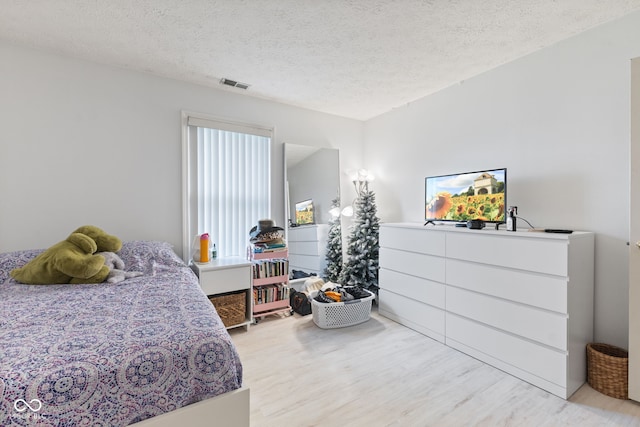 8038 Midlothian Way, Indianapolis, IN 46214 - bedroom featuring light wood finished floors and a textured ceiling