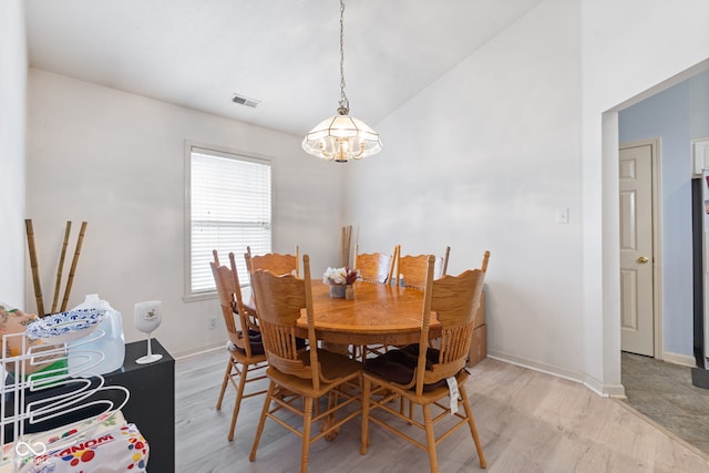 8038 Midlothian Way, Indianapolis, IN 46214 - dining area with a chandelier, light wood-type flooring, and vaulted ceiling