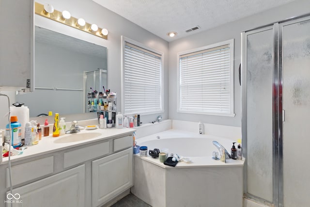 8038 Midlothian Way, Indianapolis, IN 46214 - full bathroom with vanity, a stall shower, a garden tub, and a textured ceiling
