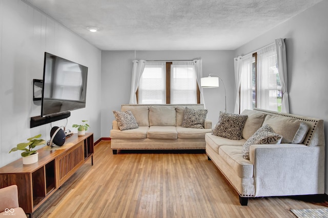 241 Wehmeier St, Columbus, IN 47201 - living room with healthy amount of natural light, hardwood / wood-style floors, and a textured ceiling