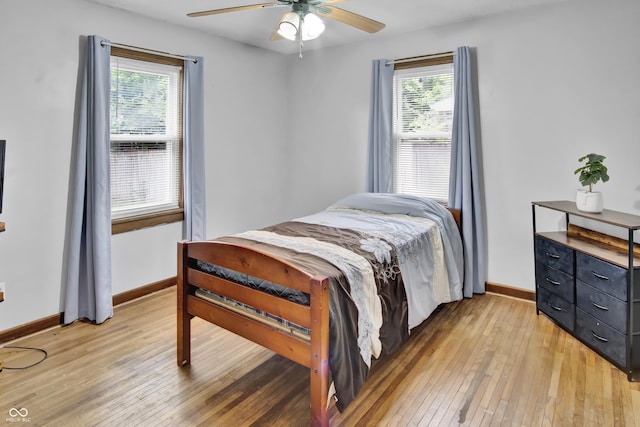 241 Wehmeier St, Columbus, IN 47201 - bedroom featuring light wood-type flooring, multiple windows, and a ceiling fan