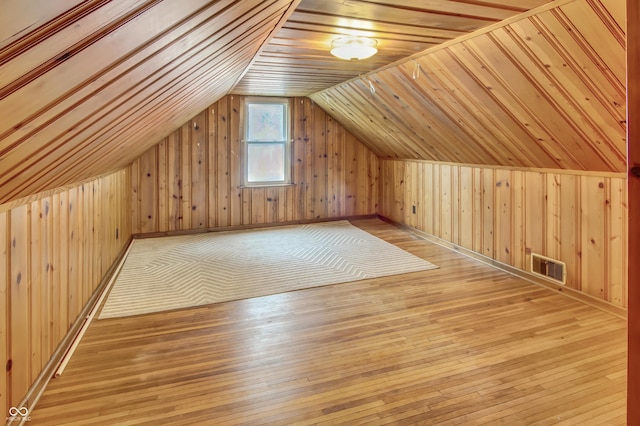 241 Wehmeier St, Columbus, IN 47201 - additional living space featuring wood walls, hardwood / wood-style flooring, and vaulted ceiling