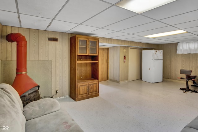 241 Wehmeier St, Columbus, IN 47201 - living room with a drop ceiling, wood walls, and a wood stove