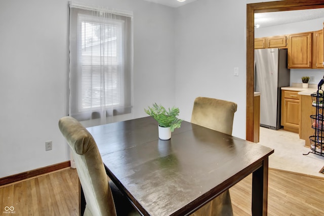 241 Wehmeier St, Columbus, IN 47201 - dining room with light wood-style flooring and baseboards