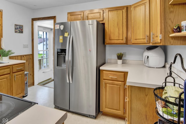 241 Wehmeier St, Columbus, IN 47201 - kitchen featuring stainless steel refrigerator with ice dispenser, light countertops, wainscoting, cooktop, and light floors
