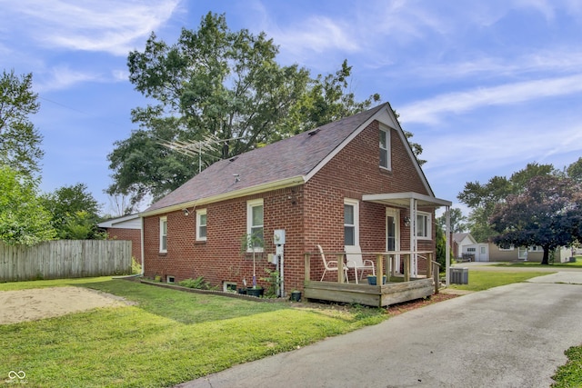 241 Wehmeier St, Columbus, IN 47201 - view of property exterior with a porch, brick siding, and roof with shingles