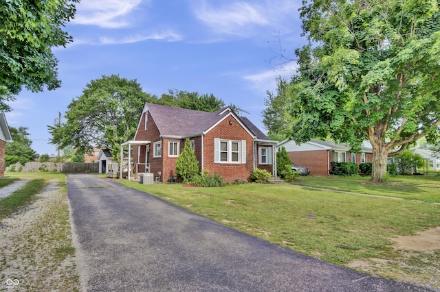 241 Wehmeier St, Columbus, IN 47201 - view of front of home with brick siding and asphalt driveway