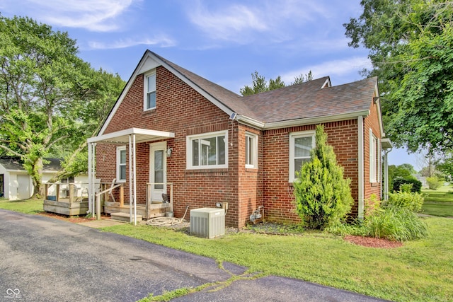 241 Wehmeier St, Columbus, IN 47201 - view of front of property featuring brick siding, a shingled roof, and a front yard