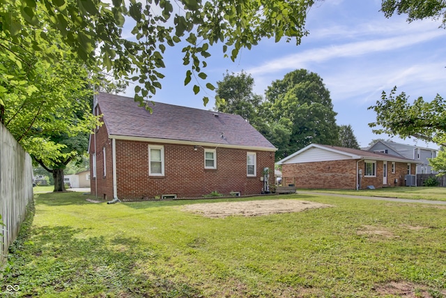 241 Wehmeier St, Columbus, IN 47201 - back of house featuring brick siding, a lawn, and roof with shingles