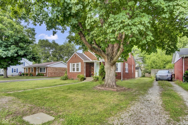 241 Wehmeier St, Columbus, IN 47201 - view of front of house featuring brick siding and a front yard