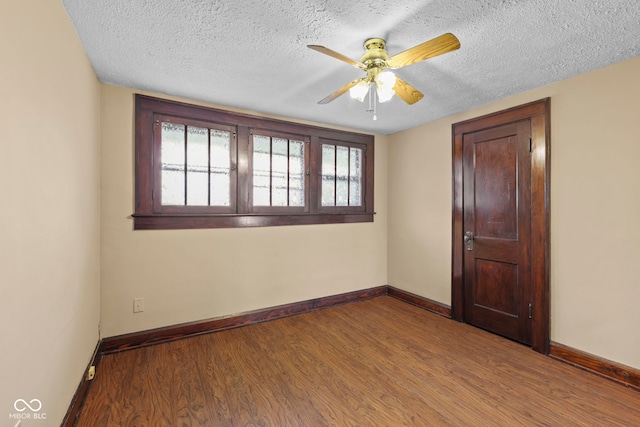 113 N Munsie St, Indianapolis, IN 46229 - empty room featuring ceiling fan, wood finished floors, and a textured ceiling