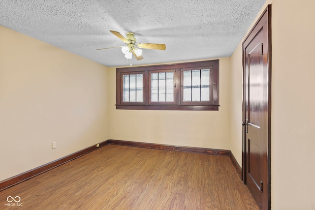 113 N Munsie St, Indianapolis, IN 46229 - unfurnished room featuring wood finished floors, ceiling fan, and a textured ceiling
