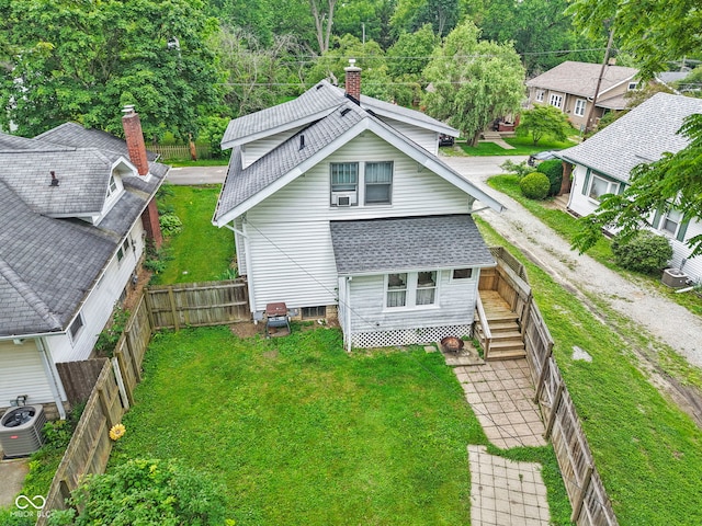 113 N Munsie St, Indianapolis, IN 46229 - back of house featuring a shingled roof, a fenced backyard, and a chimney