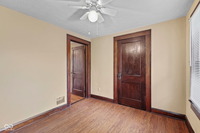 113 N Munsie St, Indianapolis, IN 46229 - unfurnished bedroom featuring light wood-style flooring and ceiling fan