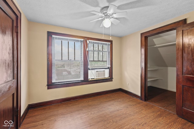 113 N Munsie St, Indianapolis, IN 46229 - unfurnished bedroom with cooling unit, a closet, wood finished floors, a textured ceiling, and ceiling fan