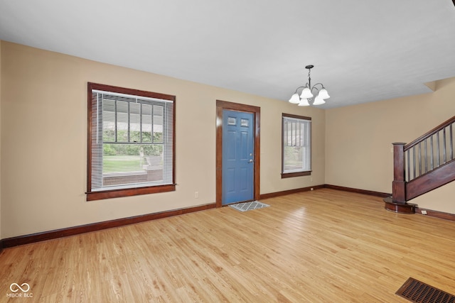 113 N Munsie St, Indianapolis, IN 46229 - entrance foyer with healthy amount of natural light, a chandelier, wood finished floors, and stairway