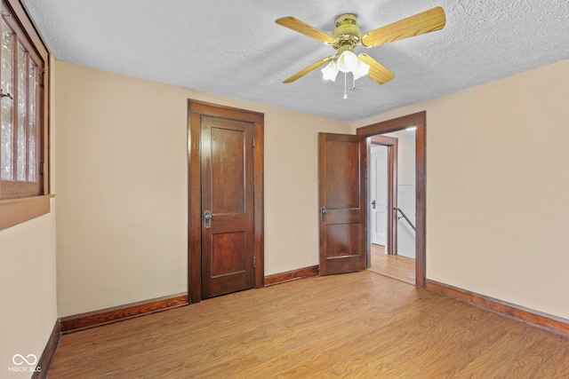 113 N Munsie St, Indianapolis, IN 46229 - spare room with light wood finished floors, a textured ceiling, and a ceiling fan