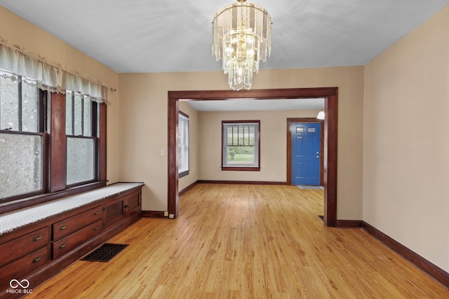 113 N Munsie St, Indianapolis, IN 46229 - unfurnished dining area with light wood-style flooring and a chandelier