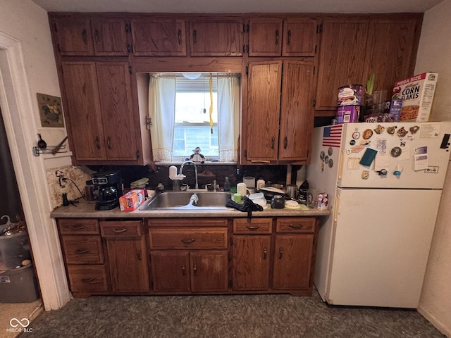 1768 N Lynhurst Dr, Speedway, IN 46224 - kitchen featuring freestanding refrigerator, light countertops, brown cabinets, and decorative backsplash