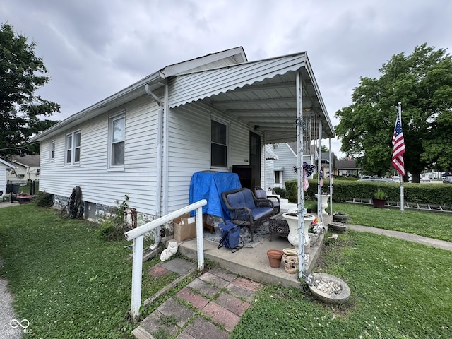 1768 N Lynhurst Dr, Speedway, IN 46224 - view of side of property featuring a lawn and a patio area