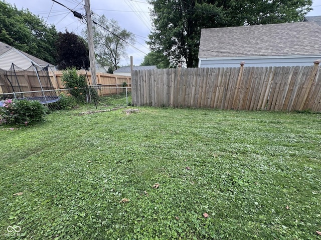 1768 N Lynhurst Dr, Speedway, IN 46224 - fenced backyard featuring a trampoline