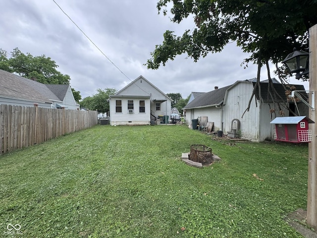 1768 N Lynhurst Dr, Speedway, IN 46224 - rear view of property featuring an outdoor fire pit and an outbuilding